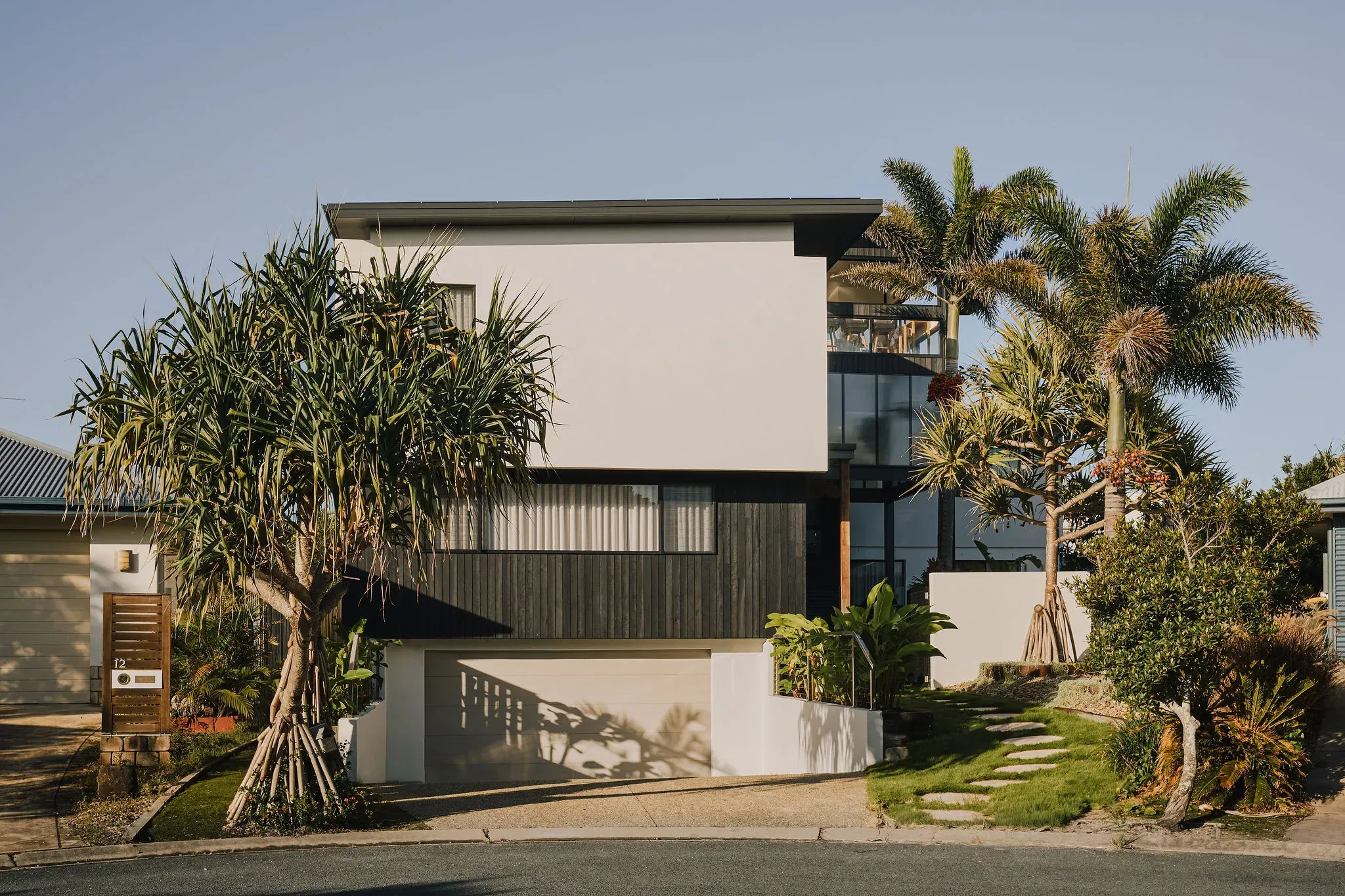 Casuarina renovation exterior with palms